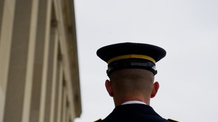 A member of a military honor guard awaits an honor cordon ceremony at the Pentagon for meetings in Washington, DC, September 23, 2013