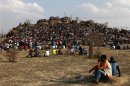 Mining community gathers at a hill dubbed the "Hill of Horror" during a memorial service for miners killed during clashes at Lonmin's Marikana platinum mine in Rustenburg