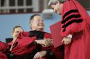 Former President George H. W. Bush, left, shakes hands with Vice President and Secretary of Harvard University Marc Goodheart, right, as Bush is awarded with an honorary Doctor of Laws degree during Harvard commencement ceremonies, Thursday, May 29, 2014, in Cambridge, Mass. (AP Photo/Steven Senne)
