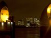 FILE - The financial center of Canary Wharf just outside the boundary of the City of London is seen through the Thames Barrier at night on Friday, Dec. 28, 2012. The low-lying city has long been vulnerable to flooding - particularly when powerful storms send seawater racing up the River Thames. But the 570-yard-long (half-a-kilometer-long) barrier, composed of 10 massive steel gates, each five stories high when raised against high water, has been in operation since 1982. (AP Photo/Alastair Grant, File)