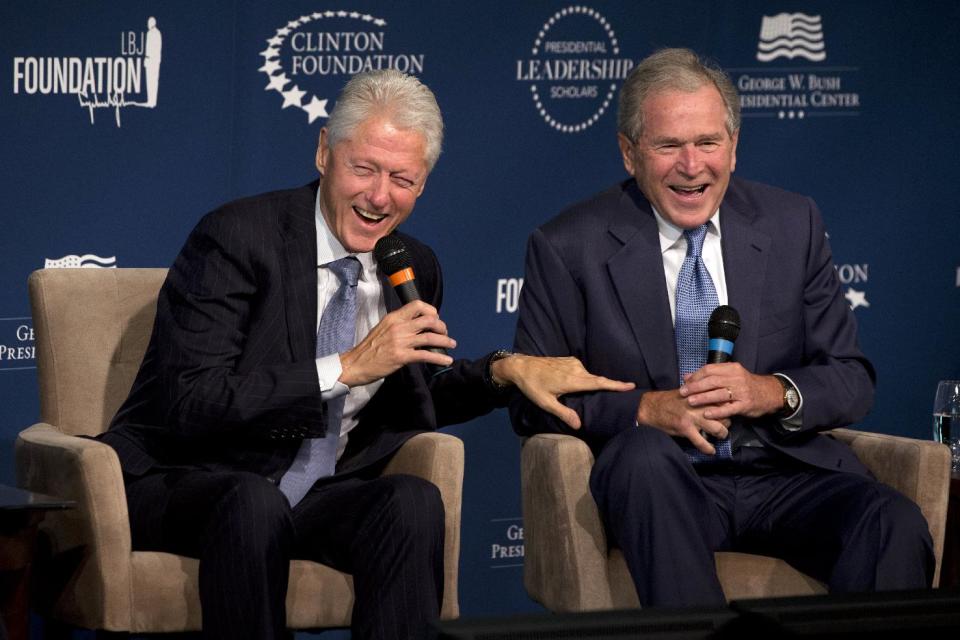 FILE - This Sept. 8, 2014, file photo shows former Presidents Bill Clinton, left, and George W. Bush, as they laugh together during the Presidential...