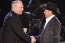 FILE - This April 6, 2009 file photo shows musician Garth Brooks, left, presenting George Strait with the Artist of the Decade award at the ACM Artist of the Decade All Star Concert in Las Vegas. Brooks and Strait will perform together for a tribute to the late Dick Clark at the 48th Annual Academy of Country Music Awards on April 7, 2013 in Las Vegas. (AP Photo/Mark J. Terrill)