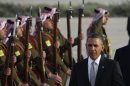 U.S. President Barack Obama is greeted by Bedouin Jordanian honour guards upon his arrival at Amman airport