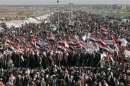 Iraqi Sunni Muslims wave the old flag of Iraq during an anti-government demonstration in Ramadi