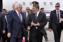 In this photo released by the Egyptian Presidency, Palestinian President Mahmoud Abbas, second left, walks with Egyptian President Mohammed Morsi, center, following Abbas' arrival in Cairo, Egypt, for the Organization of Islamic Cooperation summit, Tuesday, Feb. 5, 2013. (AP Photo/Egyptian Presidency)