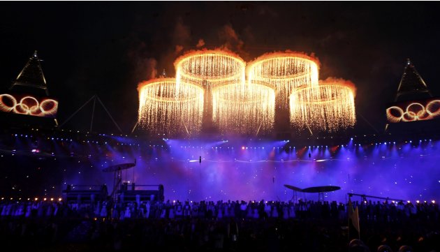The Olympic rings are seen during a pyrotechnics display at the pre-show before the opening ceremony of the London 2012 Olympic Games at the Olympic Stadium