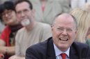 SPD top candidate Steinbrueck laughs before his speech during an election campaign in Hamburg