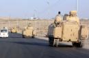 A convoy of Egyptian armoured vehicles moves along a road in El-Arish on the Sinai Peninsula on August 13, 2011