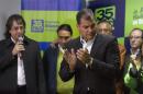 Ecuador's President Correa is introduced by the director of his political party Mora before addressing the media on the results based on exit polls in the local elections in Quito