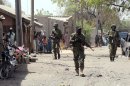 Nigerian troops patrol in the streets of Baga on April 30, 2013