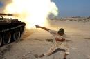 A fighter of Libyan forces allied with the U.N.-backed government fires a shell with Soviet made T-55 tank at Islamic State fighters in Sirte,