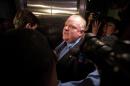 Toronto Mayor Rob Ford is surrounded by the media as he leaves his office at Toronto City Hall on November 15, 2013