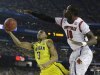 Michigan guard Trey Burke (3) shoots against Louisville center Gorgui Dieng (10) during the first half of the NCAA Final Four tournament college basketball championship game Monday, April 8, 2013, in Atlanta. (AP Photo/David J. Phillip)