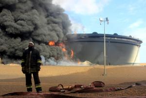 A Libyan fireman stands in front of smoke and flames&nbsp;&hellip;