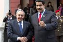 Cuba's President Raul Castro, left, shakes hands with Venezuela's President Nicolas Maduro in front of the press after arriving to Miraflores presidential palace for an emergency ALBA meeting in Caracas, Venezuela, Tuesday, March 17, 2015. The Venezuelan-led ALBA bloc of leftist regional governments is expected to express support for Venezuela's position that its sovereignty is being violated by U.S. attempts to destabilize the country. (AP Photo/Ariana Cubillos)