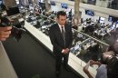 Ehab Al Shihabi, interim CEO for Al-Jazeera America, listens during an interview overlooking the newsroom, after the network's first broadcast on Tuesday, Aug. 20, 2013 in New York. The Qatar-based Al-Jazeera Media Network launched its U.S. outlet only eight months after announcing the new venture, which on Tuesday replaced Al Gore's Current TV in more than 45 million TV homes. (AP Photo/Bebeto Matthews)
