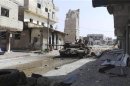 Abandoned tank is seen on a street near the damaged minaret of the Omari mosque in Deraa