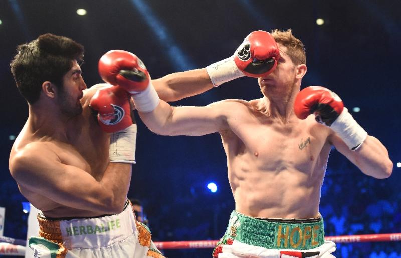 Indian Boxer Vijender Singh (L) fights with Australian Boxer Kerry Hope for the WBO Asia Pacific Super Middleweight title in New Delhi on July 16, 2016 (AFP Photo/Prakash Singh)