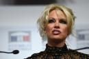 US actress Pamela Anderson gives a press conference after attending a session of questions to the Government at the French National Assembly in Paris on January 19, 2016