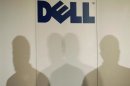 Shadows of Michael Dell, chairman of the board and chief executive officer of Dell, are cast under the company logo as he speaks during a press briefing in Tokyo