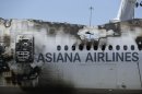 The wreckage of Asiana Flight 214, which crashed on Saturday, July 6, 2013, seen at San Francisco International Airport, in San Francisco, Friday, July 12, 2013. Two people were killed and dozens of others injured although most suffered minor injuries. Investigators have said the plane came in too low and slow. (AP Photo/Jeff Chiu)