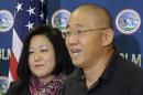 Kenneth Bae, right, who had been held in North Korea since 2012, talks to reporters after he arrived Saturday, Nov. 8, 2014, at Joint Base Lewis-McChord, Wash., after he was freed during a top-secret mission. At left is his sister Terri Chung. (AP Photo/Ted S. Warren)