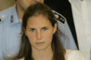 FILE - In this Tuesday Sept. 16, 2008 file photo, then murder suspect Amanda Knox is escorted by Italian penitentiary police officers from Perugia's court after a hearing, central Italy. Few international criminal cases have cleaved along national biases as that of American student Amanda Knox, awaiting half world away her third Italian court verdict in the 2007 slaying of her British roommate, 21-year-old Meredith Kercher. Whatever is decided this week, the protracted legal battle that has grabbed global headlines and polarized trial-watchers in three nations probably won't end in Florence. With the first two trials producing flip-flop guilty-then-innocent verdicts against Knox and her former Italian boyfriend, Raffaele Sollecito, the case has produced harshly clashing versions of events. A Florence appeals panel designated by Italy's supreme court to address errors in the appeals acquittal is set to deliberate Thursday, Jan. 30, 2014, with a verdict expected later in the day .(AP Photo/Antonio Calanni, File)