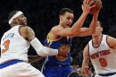 Golden State Warriors' Curry drives between New York Knicks' Martin and Prigioni in their NBA basketball game in New York