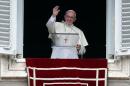Pope Francis waves as he leads the Angelus prayer in Saint Peter's Square at the Vatican
