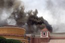 Smoke rises above the Villaggio Mall, in Doha's west end, as a fire took hold of the upscale mall in the Qatari capital of Doha Monday May 28, 2012. Qatar's Interior Ministry said 13 children were among 19 people killed in a fire that broke out at one of the Gulf state's fanciest shopping mall on Monday. The Villaggio opened in 2006 and is one of Qatar's most popular shopping and amusement destinations. It includes an ice skating rink and indoor Venice-style gondola rides. (AP Photo/Osama Faisal)