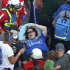 A spectator, center, is transported from the grandstands by emergency personnel after Kyle Larson's car hit the safety wall and fence along the front stretch on the final lap of the NASCAR Nationwide Series auto race at Daytona International Speedway in Daytona Beach, Fla., Saturday, Feb. 23, 2013. Several fans were injured when large chunks of debris flew into the grandstands. (AP Photo/Phelan M. Ebenhack)