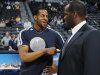 Denver Nuggets guard Andre Iguodala, left, who was acquired in an off-season trade last year from the Philadelphia 76ers, jokes with 76ers television analyst Malik Rose before the first quarter of an NBA basketball game in Denver, Thursday, March 21, 2013. (AP Photo/David Zalubowski)