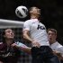 Manchester United's Rio Ferdinand, center, is watched by Phil Jones, right, as he gets to the ball ahead of West Ham's Andy Carroll, left, during the English Premier League soccer match between West Ham and Manchester United at Upton Park stadium in London, Wednesday, April 17, 2013.  (AP Photo/Matt Dunham)