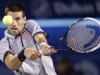 Djokovic of Serbia hits a return to compatriot Troicki during their men's singles match at the Dubai Tennis Championships