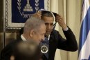 President Barack Obama, accompanied by Israeli Prime Minister Benjamin Netanyahu, left, removes his Israeli Medal of Distinction, which he received at the State Dinner at President's residence in Jerusalem, Israel, Thursday, March 21, 2013. (AP Photo/Pablo Martinez Monsivais)