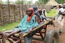 Woman is transported on cart to International Medical Corps' clinic in Gendrassa camp in Maban