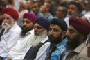 Sikh minority men listen to a speech by Afghanistan's President Karzai during a ceremony to mark the second anniversary of the assassination of the former head of High Peace Council Rabbani in Kabul