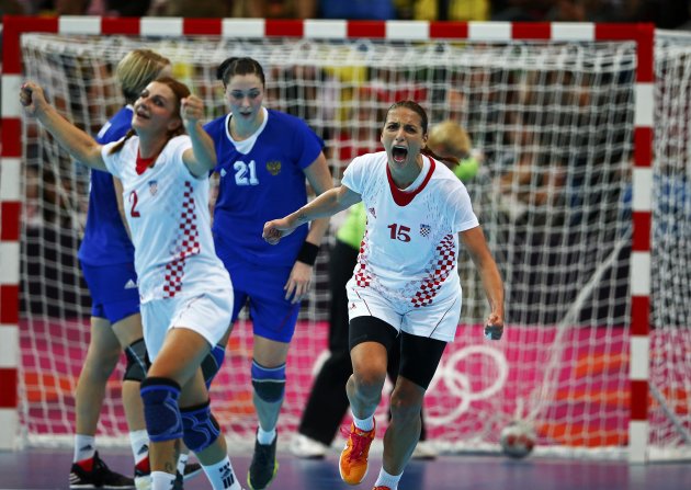 Croatia's Miranda Tatari and Andrea Penezic celebrate a goal against Russia in their women's handball Preliminaries Group A match at the Copper Box venue during the London 2012 Olympic Games