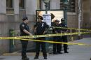 Police investigate the scene of a shooting at a federal office building in Lower Manhattan, New York