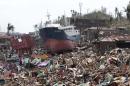 A ship lies on top of damaged homes after it was washed ashore in Tacloban city, Leyte province, central Philippines on Sunday, Nov. 10, 2013. The city remains littered with debris from damaged homes as many complain of shortages of food and water and no electricity since Typhoon Haiyan slammed into their province. Haiyan, one of the most powerful storms on record, slammed into six central Philippine islands on Friday, leaving a wide swath of destruction and scores of people dead. (AP Photo/Aaron Favila)