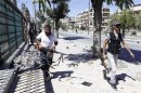 Syrian rebel fighters run for cover from heavy fighting in the Saif al-Dawla district in the centre of Aleppo city