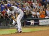 Texas Rangers pitcher Darvish watches after a hit by Houston Astros' Gonzalez goes through his legs in their MLB American League baseball game in Houston