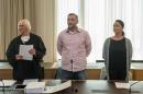Lutz Bachmann (C), co-founder of Germany's xenophobic and anti-Islamic PEGIDA movement, stands between his lawyer Katja Reichel (L) and his wife Vicky Bachmann (R) on May 3, 2016 in Dresden, eastern Germany