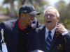 Tiger Woods, left, and Arnold Palmer share a laugh during the trophy presentation after Woods won the Arnold Palmer Invitational golf tournament in Orlando, Fla., Monday, March 25, 2013. (AP Photo/Phelan M. Ebenhack)