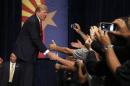 Republican presidential candidate Donald Trump shakes hands prior to speaking at a rally before a crowd of 3,500 Saturday, July 11, 2015, in Phoenix. (AP Photo/Ross D. Franklin)