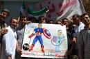 Anti-government protestors hold a poster depicting US President Barack Obama (L) and his Syrian counterpart Bashar al-Assad during a demonstration to call for international action against the Damascus regime on September 6, 2013 in Kafranbel