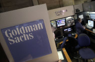 FILE - In a March 15, 2012 file photo a trader works in the Goldman Sachs booth on the floor of the New York Stock Exchange. Moody's Investors Service has lowered the credit ratings on some of the world's biggest banks, including Goldman Sachs. (AP Photo/Richard Drew, file)