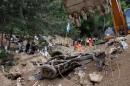 Wreckage of a car is seen at an area affected by a mudslide in Santa Catarina Pinula, on the outskirts of Guatemala City