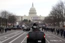 President Barack Obama and first lady Michelle Obama ride up Pennsylvania Avenue in the presidential motorcade towards the U.S. Capitol in Washington, Monday, Jan. 21, 2013, ahead of his ceremonial swearing in during the 57th Presidential Inauguration. (AP Photo/Charles Dharapak)