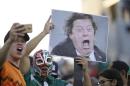 Mexico fans hold an image of head coach Miguel Herrera as they cheer before the first half of the CONCACAF Gold Cup championship soccer match between Mexico and Jamaica, Sunday, July 26, 2015, in Philadelphia. (AP Photo/Michael Perez)